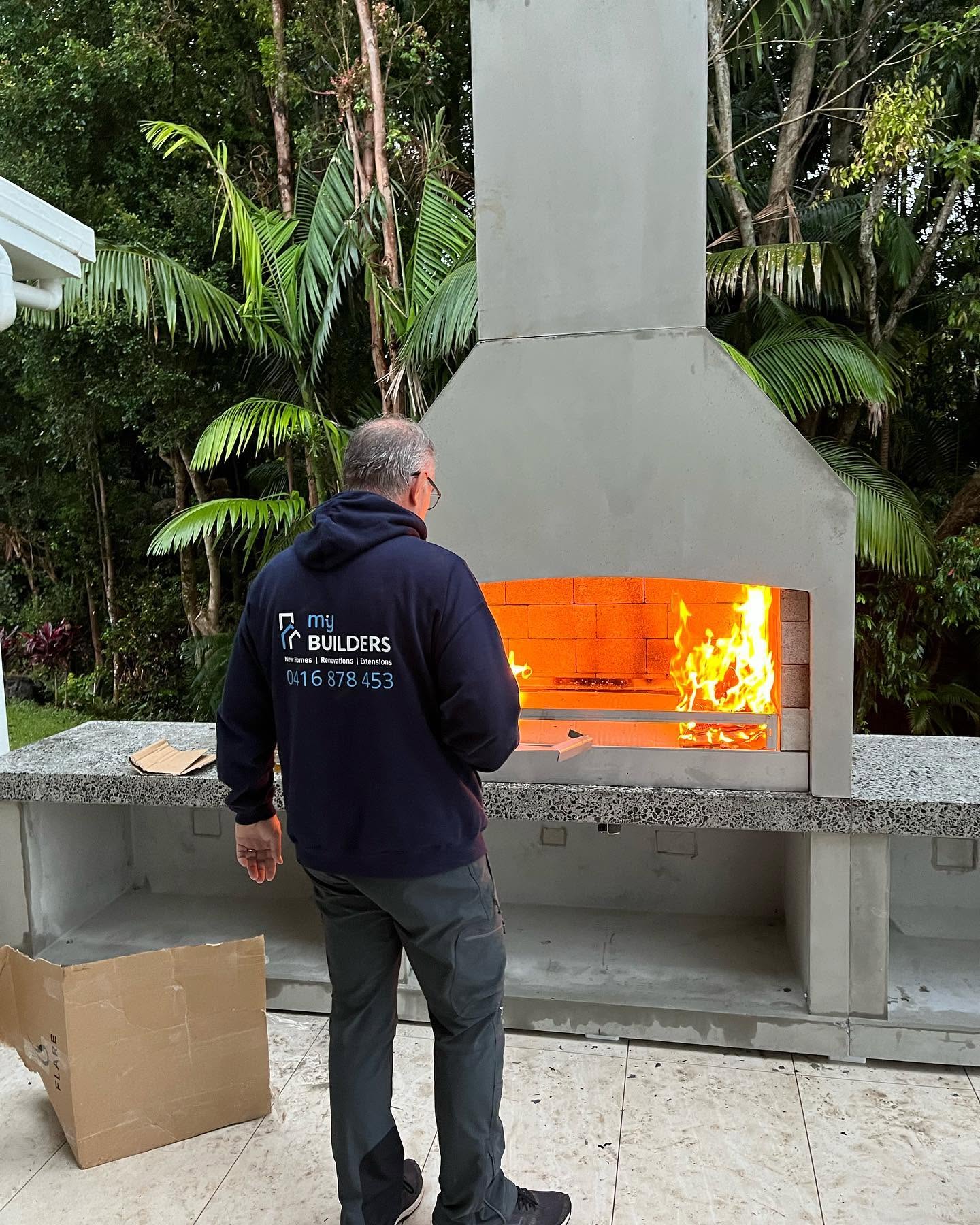 MIY Builders team member finishing an outdoor fireplace